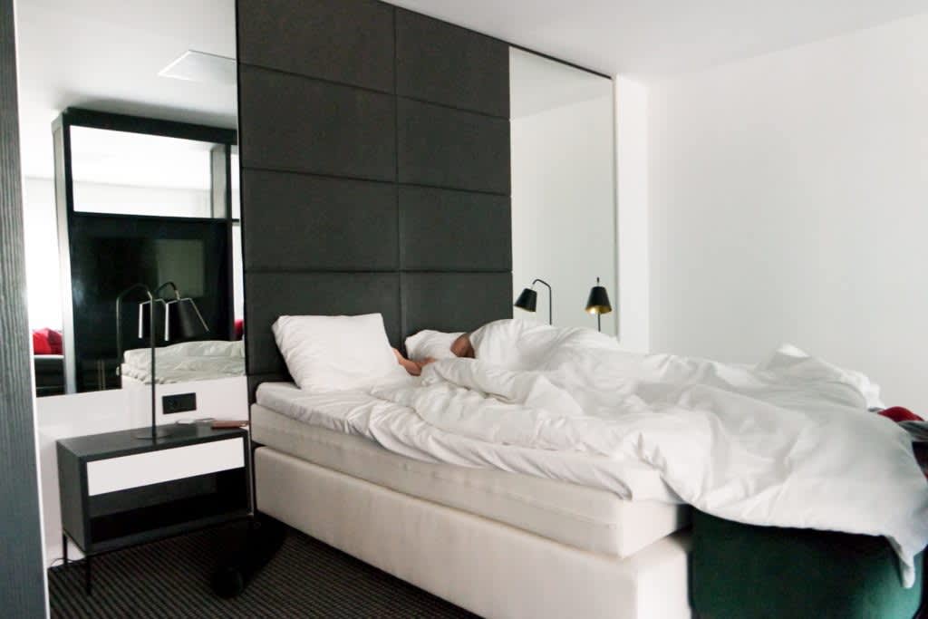 Man sleeping in modern hotel room.