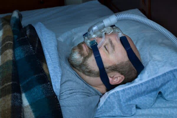 stock photo of a man using a cpap machine